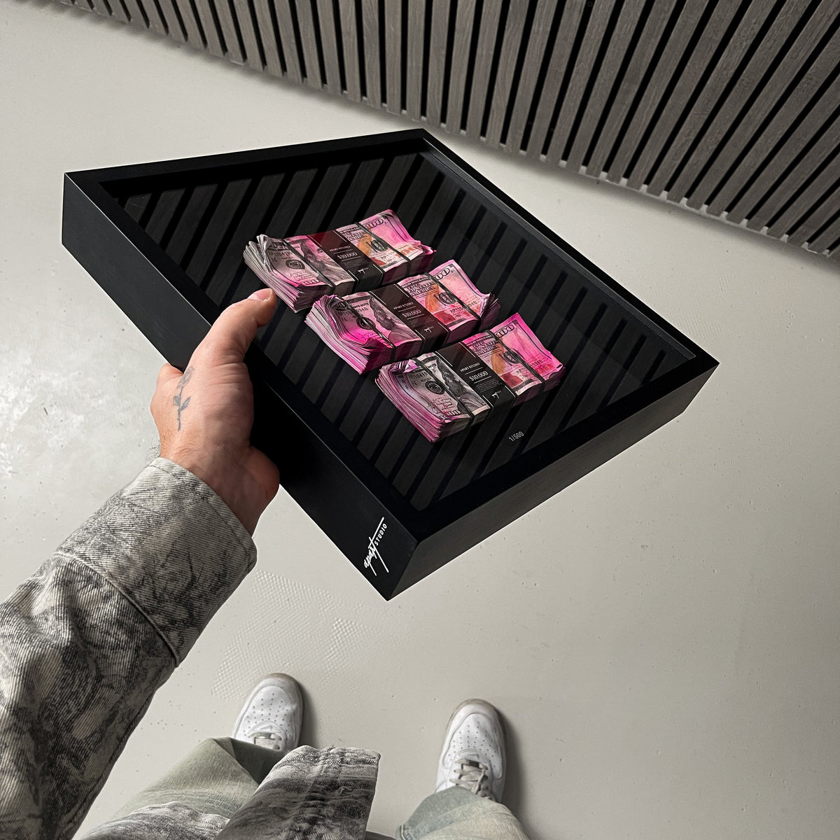 Bank Heist Frame USD held in hand showing handmade 3D dollar bill framed artwork by Apart Studio