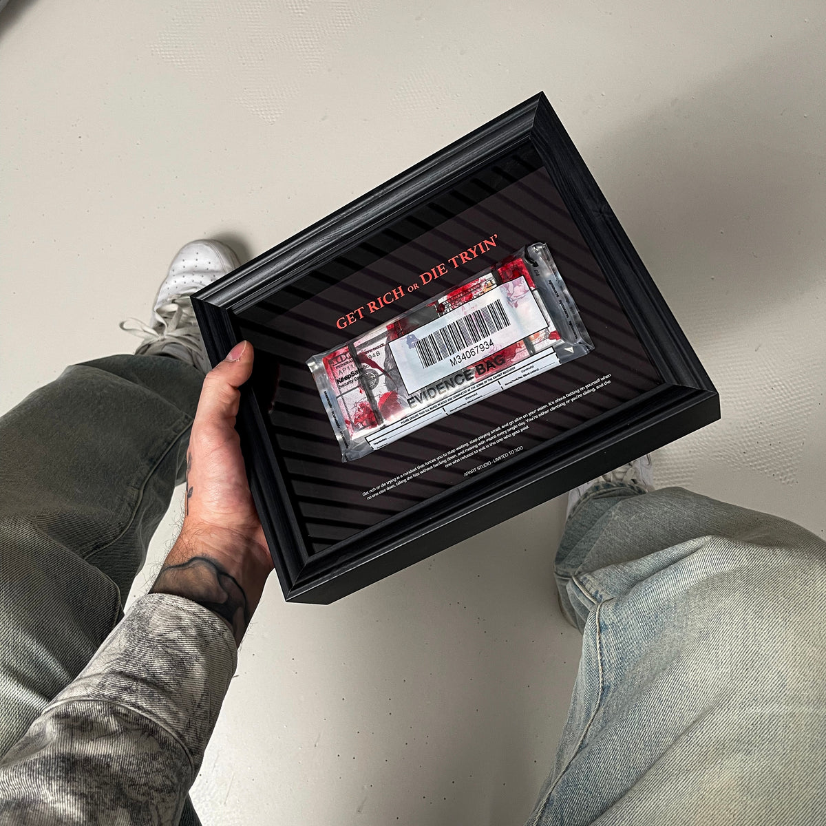 Get Rich or Die Tryin Frame held in hand showing the handmade 3D constructed money artwork