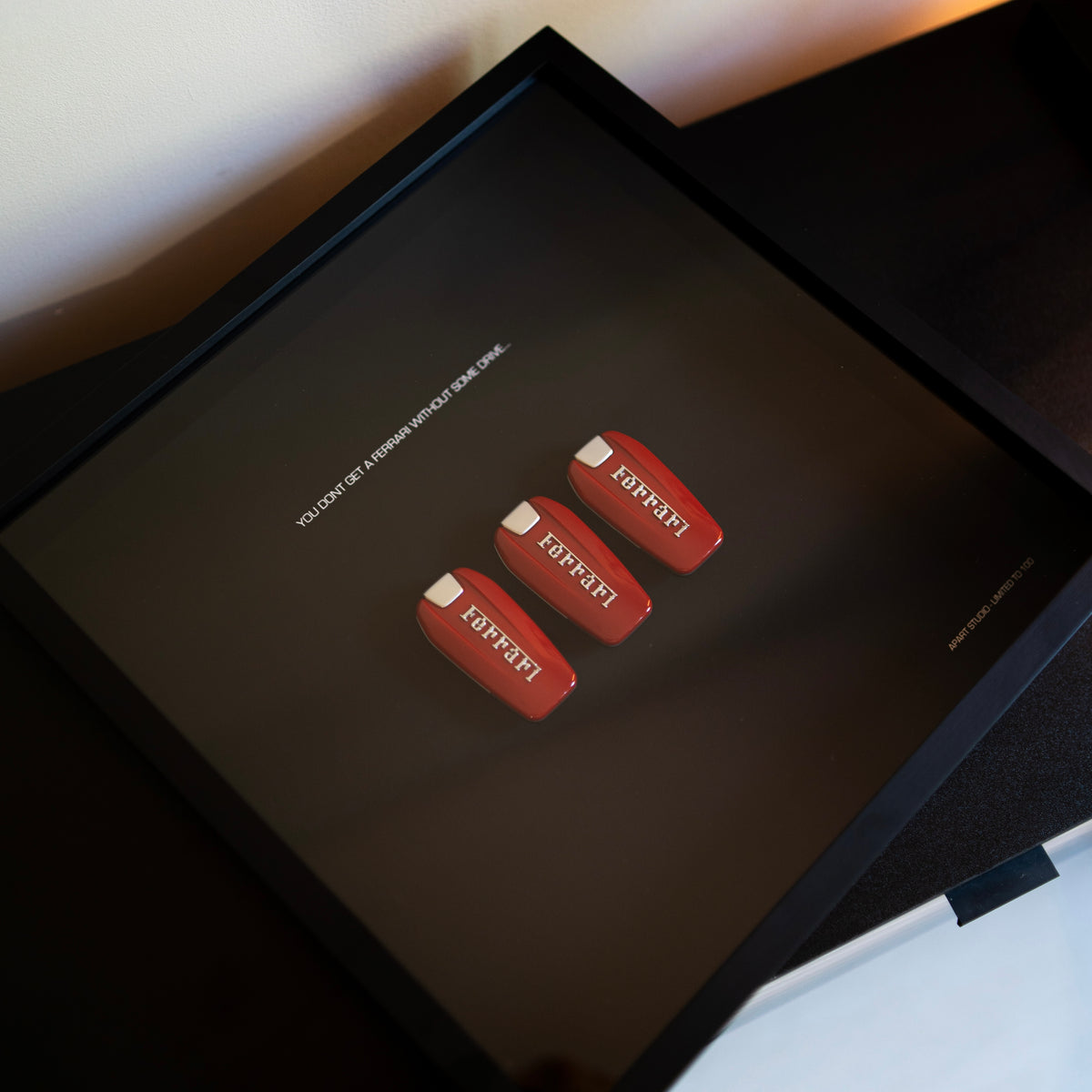 The Drive Frame Ferrari held in hand showing the handmade 3D Ferrari artwork in black frame