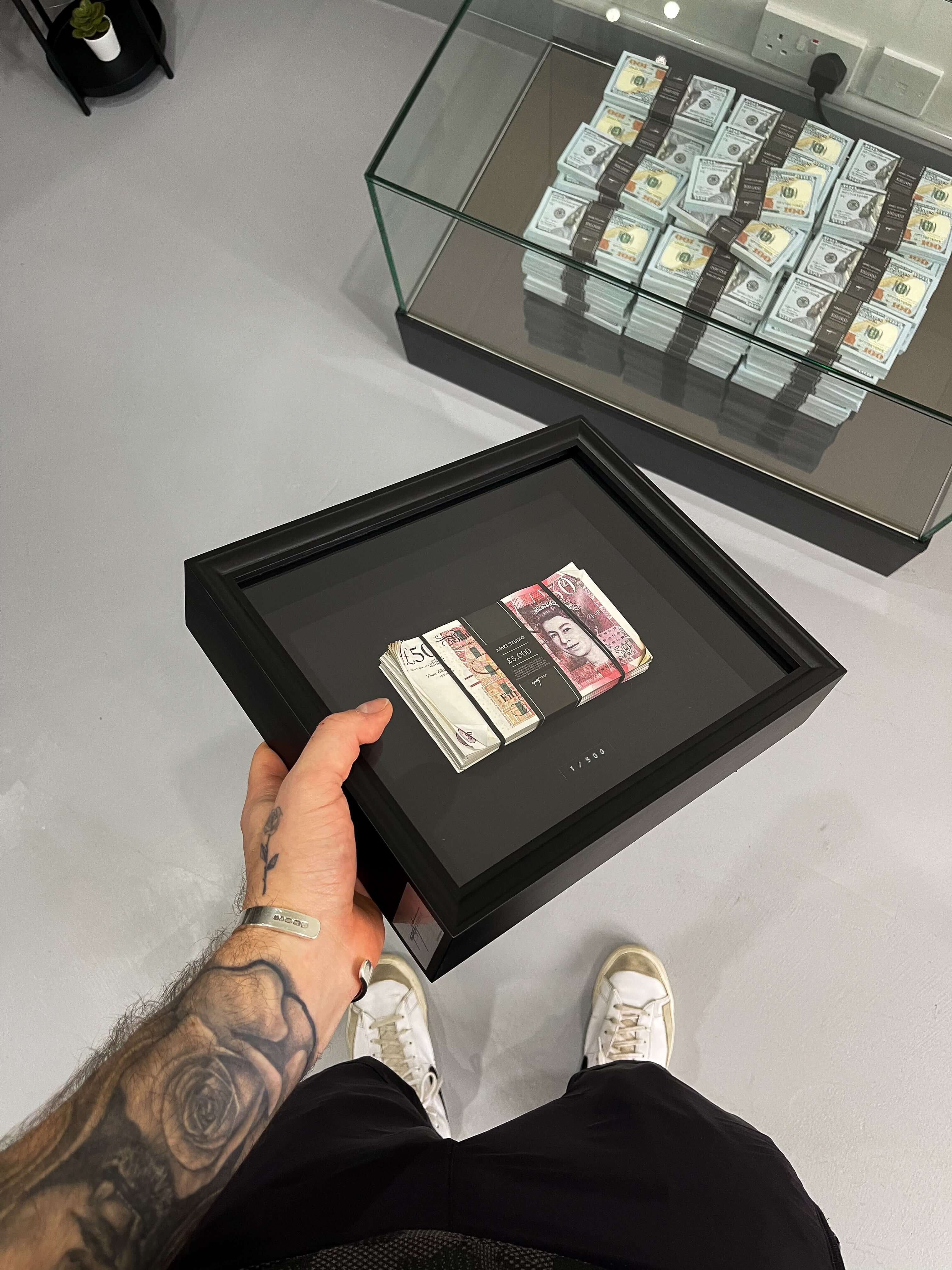 Aged Stacked Frame GBP held in hand showing the aged British fifty pound notes wrapped in a custom satin band