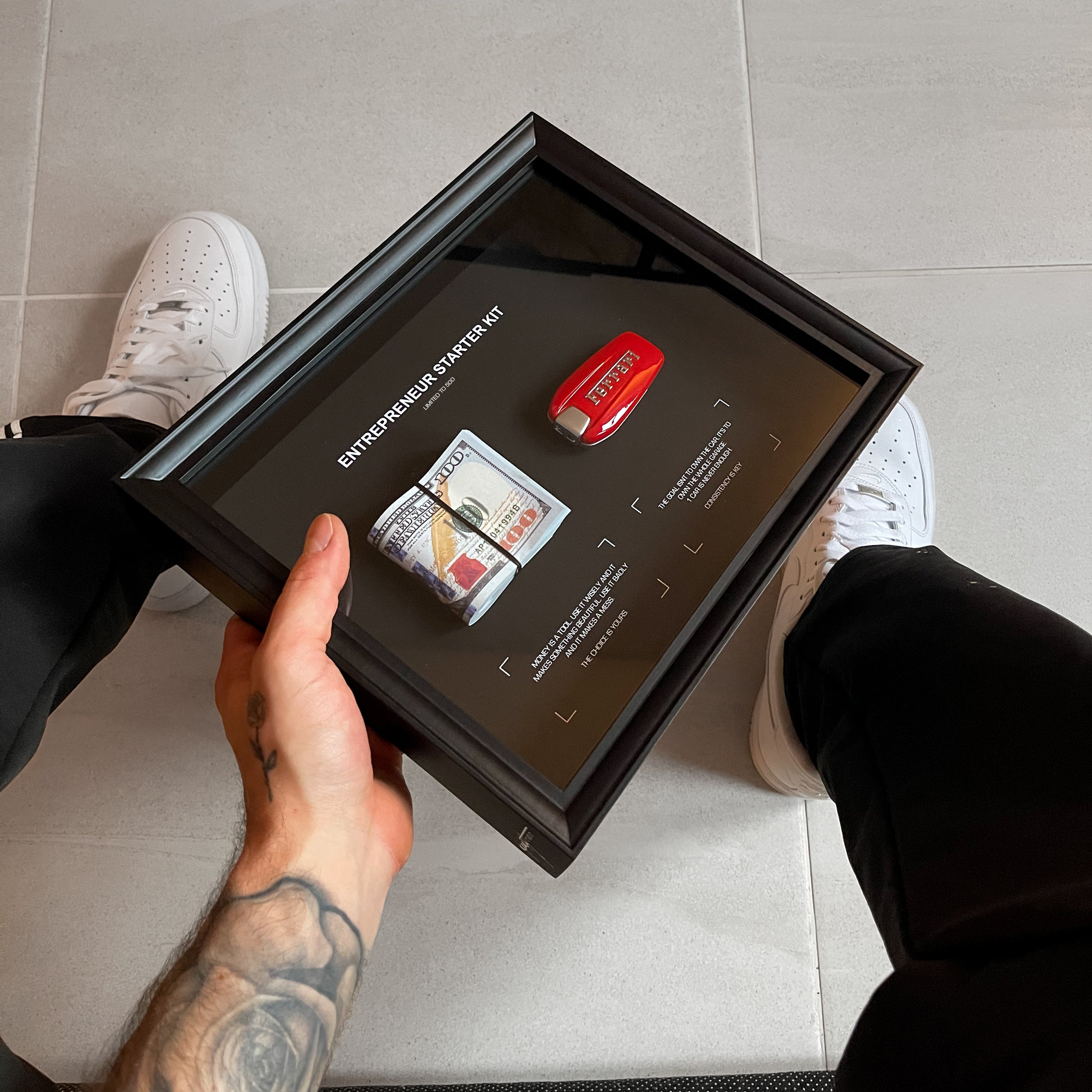 Entrepreneur Starter Kit Ferrari held in hand showing the complete bundle presentation