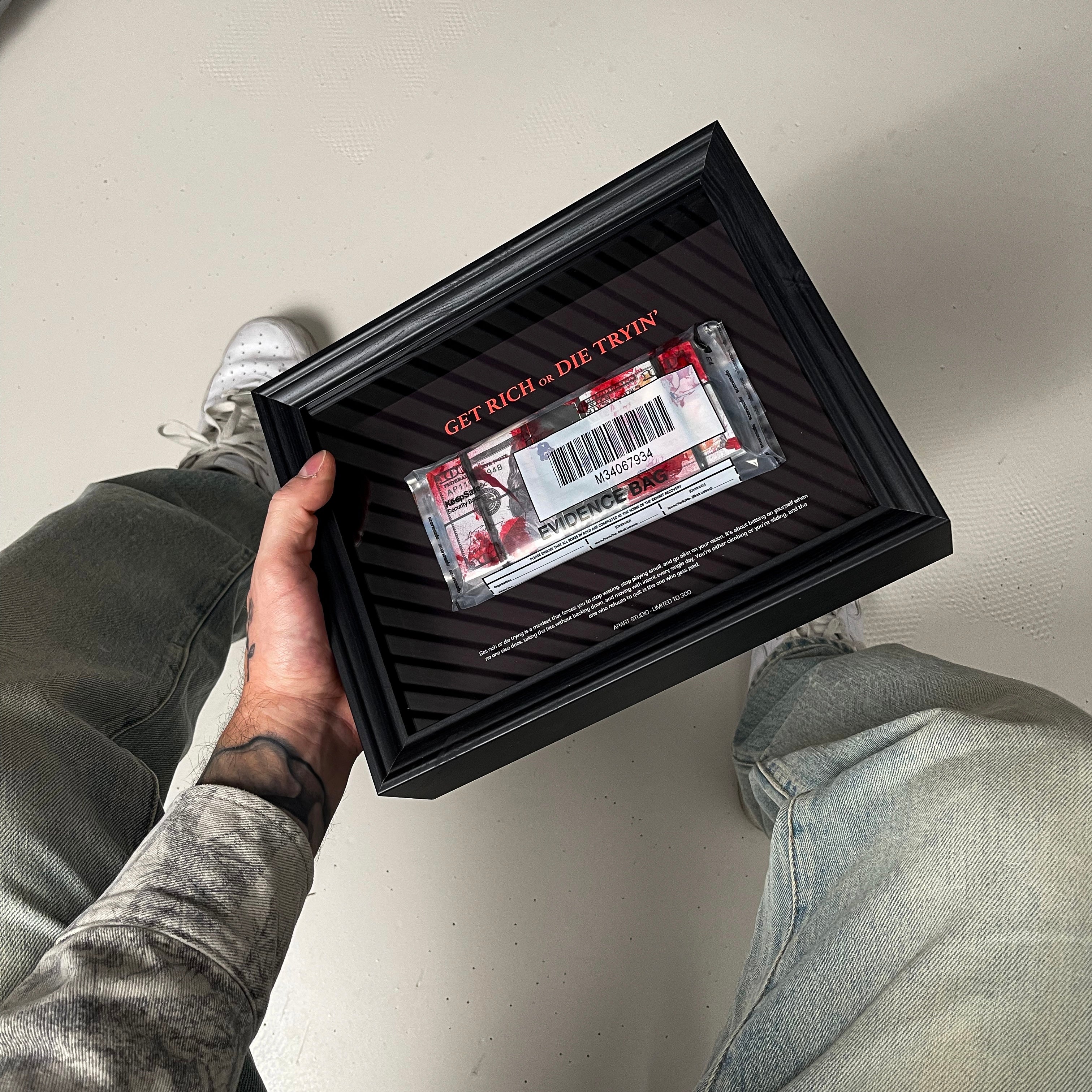 Get Rich or Die Tryin Frame held in hand showing the handmade 3D constructed money artwork