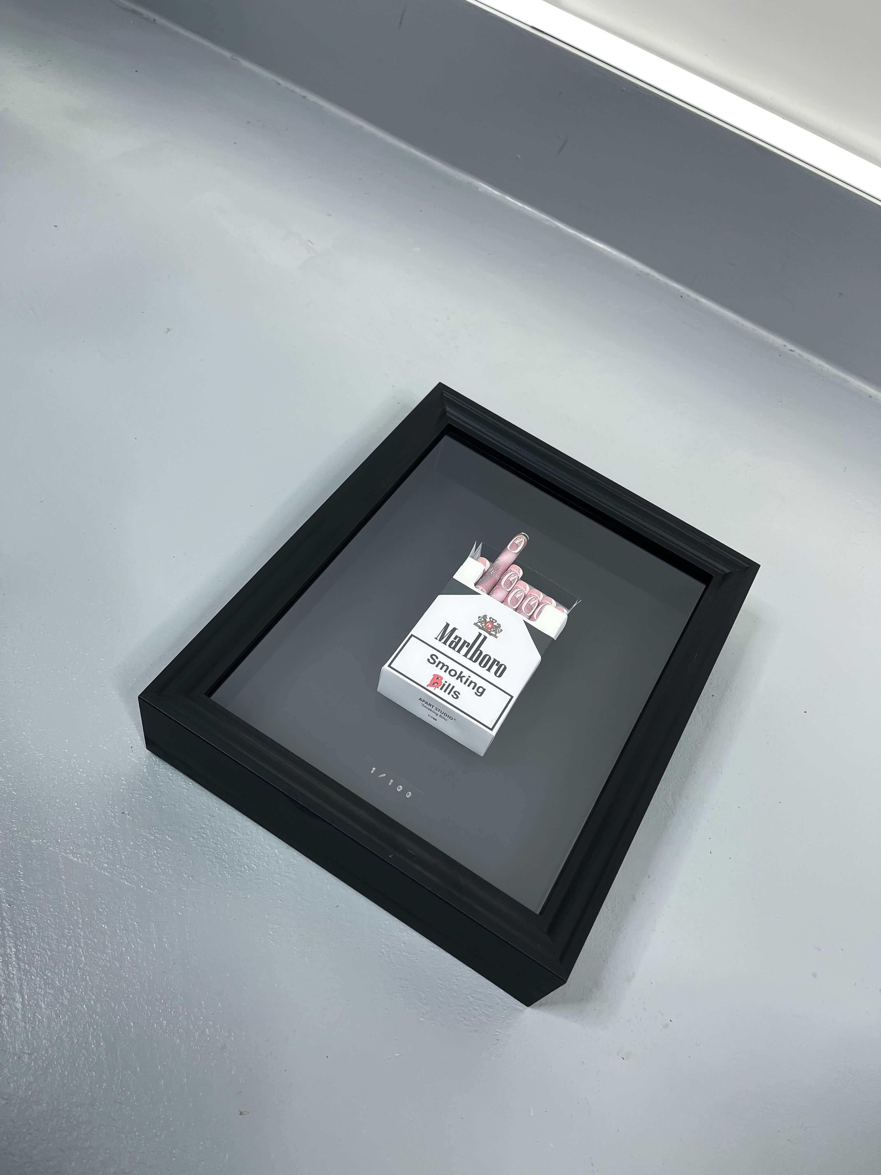 Black GBP Smoking Bills artwork angled view showing handmade cigar and pound note construction in black frame